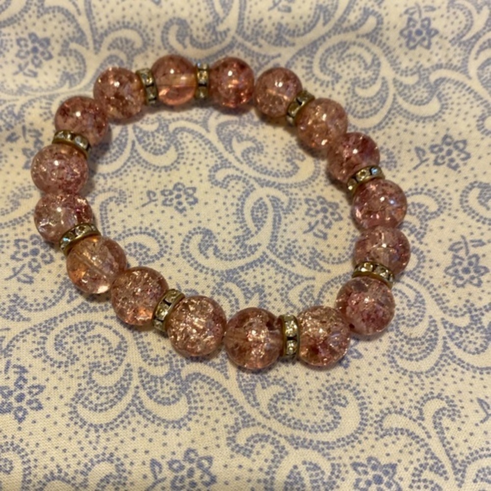 Crackled pink beads and clear rhinestone bracelet. Stretchy.